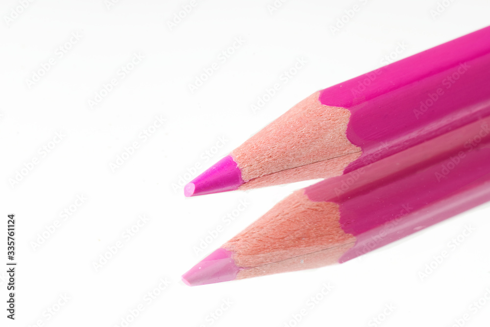 Pink pencil with reflection lies on a mirror Pink pencil with reflection lies on a mirror