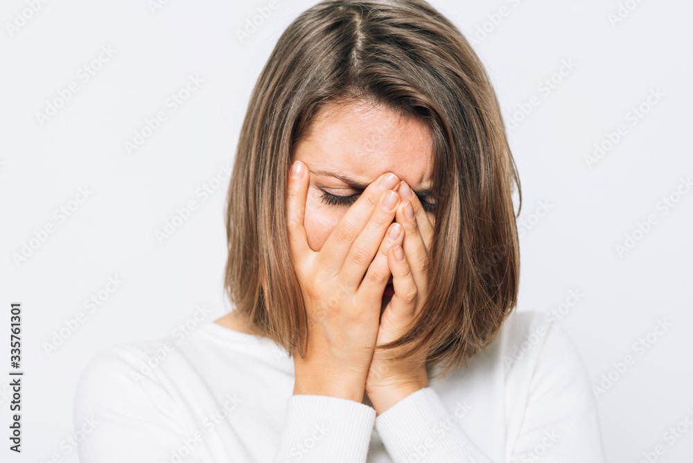 Woman covers his face by hand Woman covers his face by hand