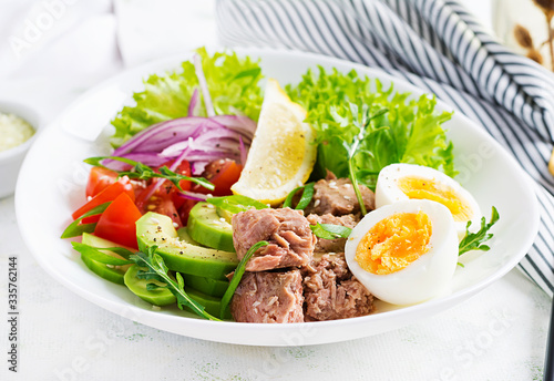 Healthy food. Tuna fish salad with eggs, lettuce, cherry tomatoes, avocado and red onions. French cuisine.