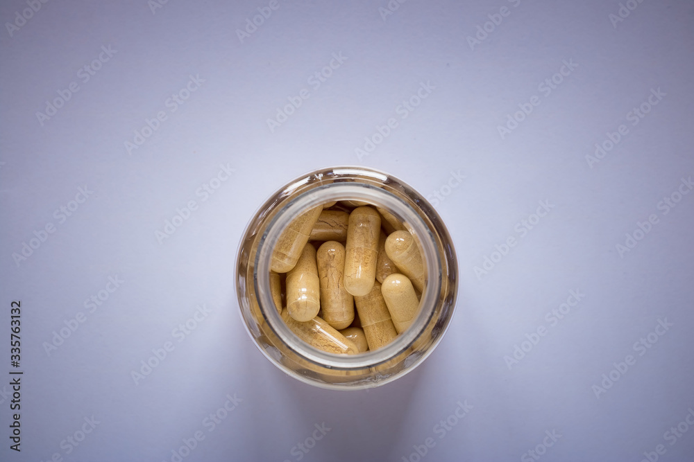 yellow pills in a jar