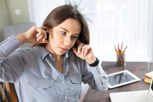 Young woman with ear ache photo