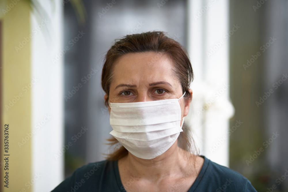 close up portrait of woman wearing surgical mask because of viruses and air pollution. Covid-19.