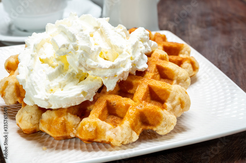 Tasty Belgian dessert, Brussels sugar waffles with  whipped cream