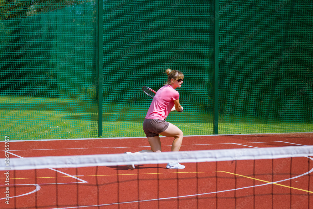 Female tennis player hitting a two-handed backhand