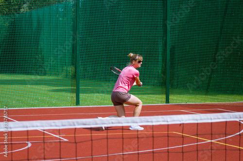 Female tennis player hitting a two-handed backhand