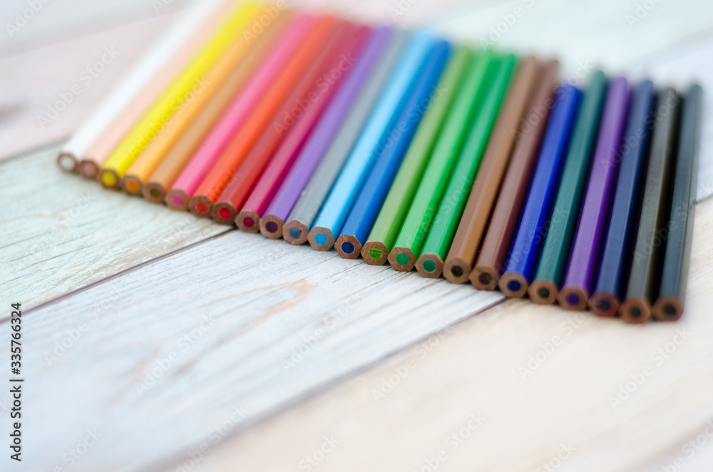 Fototapeta premium colored pencils on wooden background