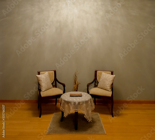 Modern seating arrangement with empty wall facade in the background shot for artists to place their painting frames. 