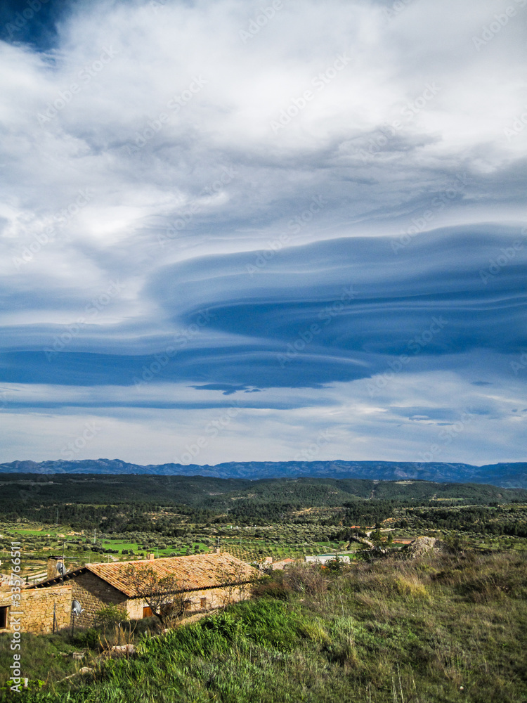 Lenticular clouds over rural landscape, Matarraña, teruel