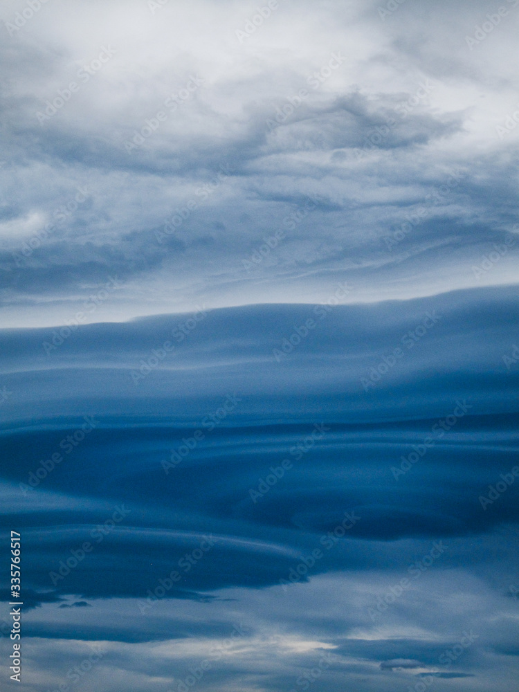 Fototapeta premium Blue lenticular clouds form in the sky at evening