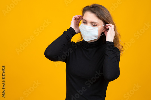 Coronavirus. Girl puts on a...