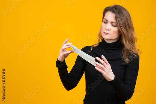 A woman examines a gauze ba...
