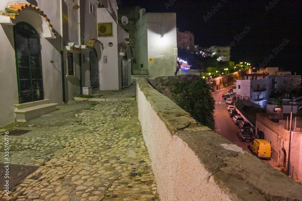 Obraz premium Night view of a picturesque view of the streets of the historic center of the ancient seaside village of the city of Peschici on the Gargano in Italy.