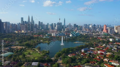 February 23rd, 2020 - Kuala Lumpur, Malaysia : 4k Establishing b-roll aerial shot of drone moving forward towards Kuala Lumpur city skyline. Flying over Titiwangsa Lake. Green and Sustainable City photo