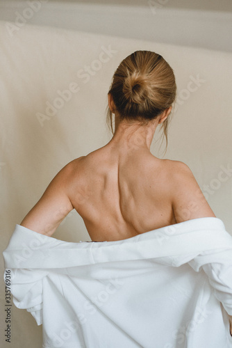 Sensual portrait of a young attractive woman in a white blazer.