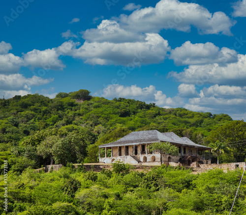 An old, abandoned stone house on a green hill on Antigua