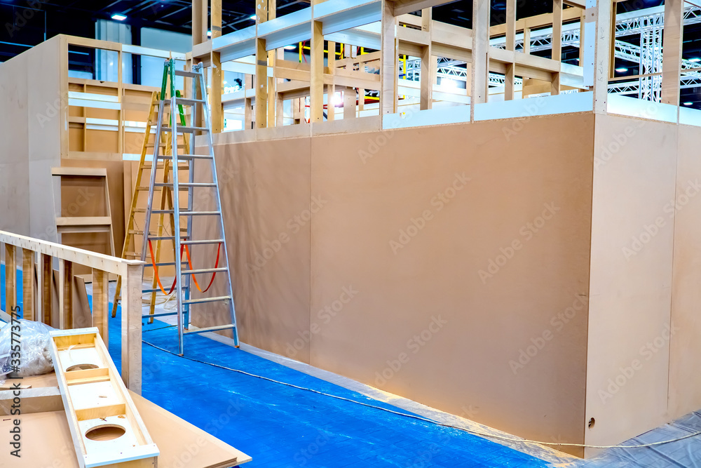 Construction work in a large room. Production of plywood frames. Dividing a large room into