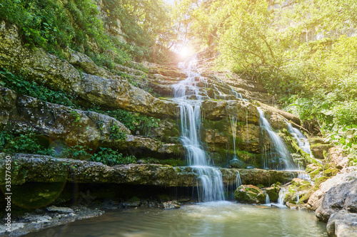 Fototapeta Naklejka Na Ścianę i Meble -  Mountain waterfall in the forest, a large noisy stream of water