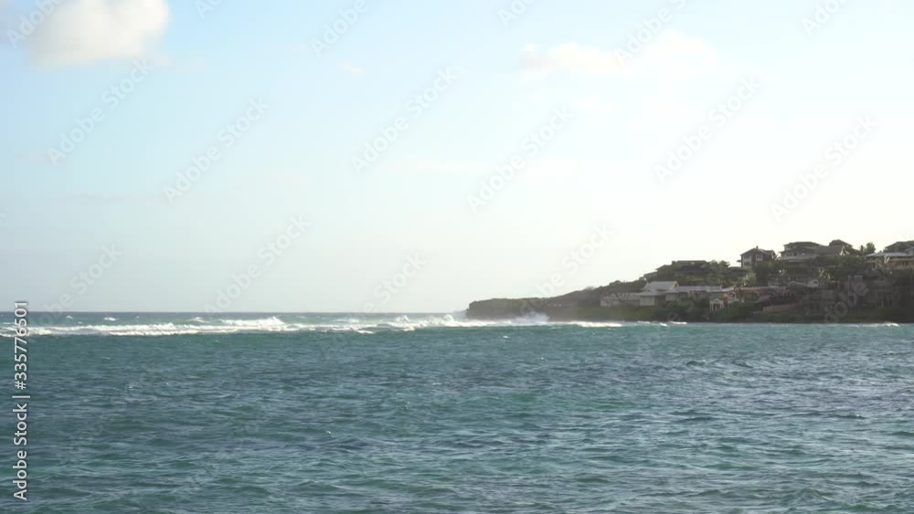 Ocean waves are breaking on the reef coast. Foamy waves in a windy day. Ocean waves are breaking on the reef coast. Foamy waves in a windy day.