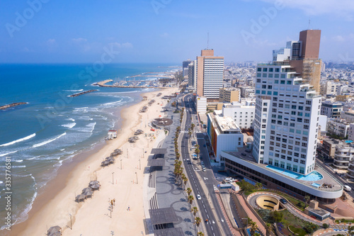 Corona Virus lockdown, Aerial view of Tel Aviv coastline with no people and traffic in the Streets and Beach, pull up from Ben Gurion statue on the Beach. photo