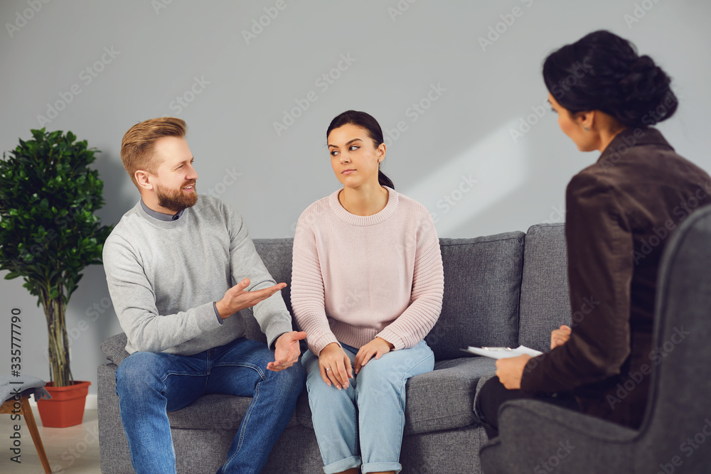 Family psychologist. Female psychologist at a psychotherapy session with family in the office. Family psychologist. Female psychologist at a psychotherapy session with family in the office.