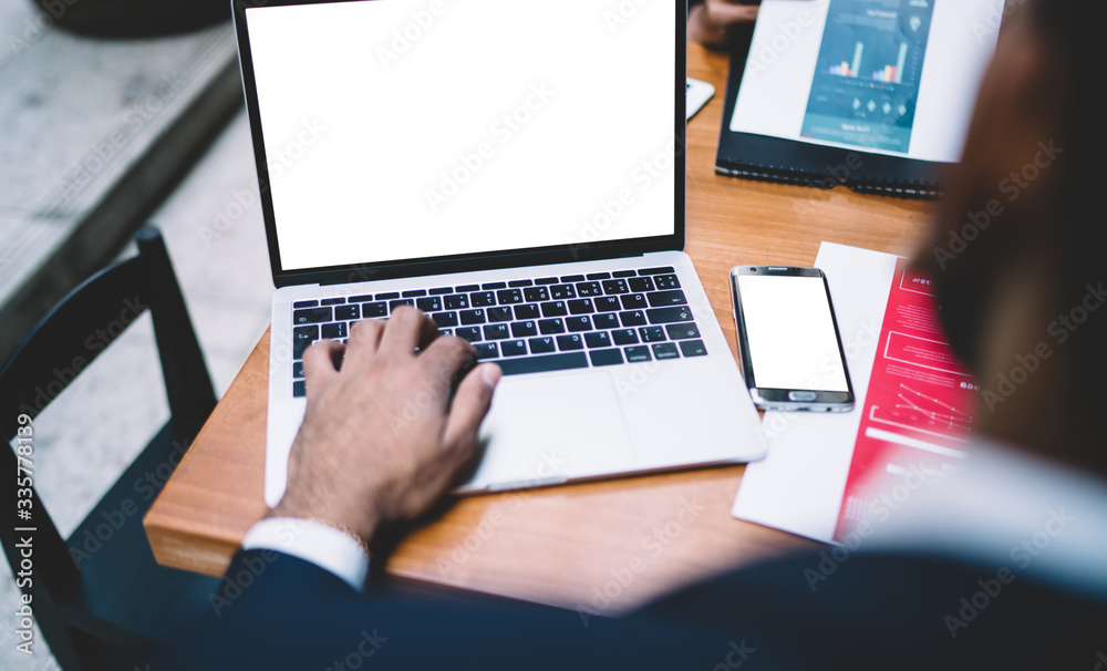 Faceless man surfing laptop in office Faceless man surfing laptop in office