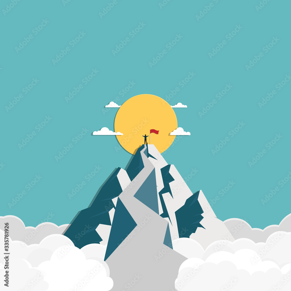 Success businessman stands on top of the mountain