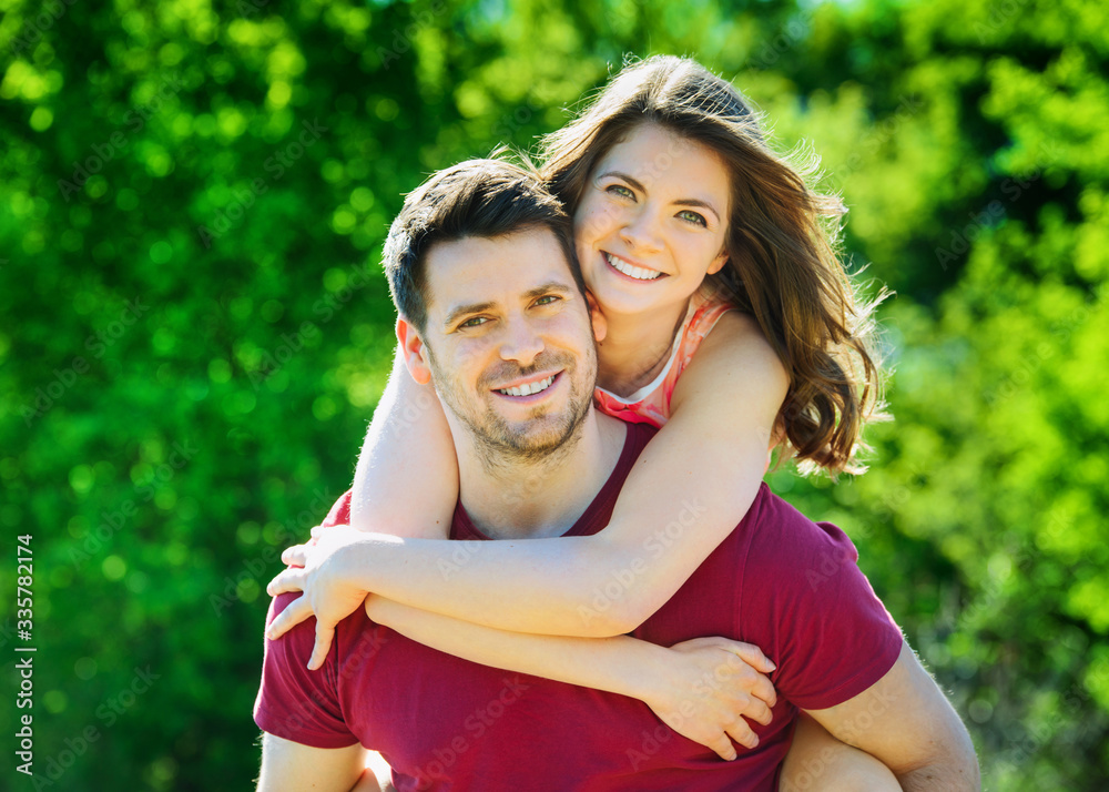 Happy couple in the park on a sunny day having fun Happy couple in the park on a sunny day having fun
