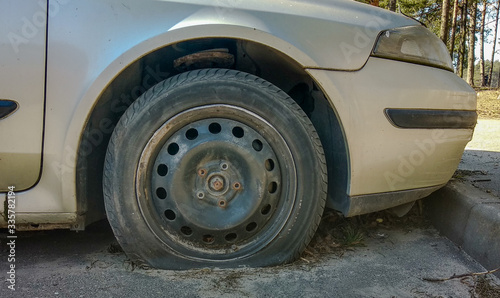 Flat tire and rusted wheel in a car parked for a long time