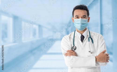 Doctor at hospital wearing medical mask to protect against coronavirus 2019 disease or COVID-19 global outbreak. photo