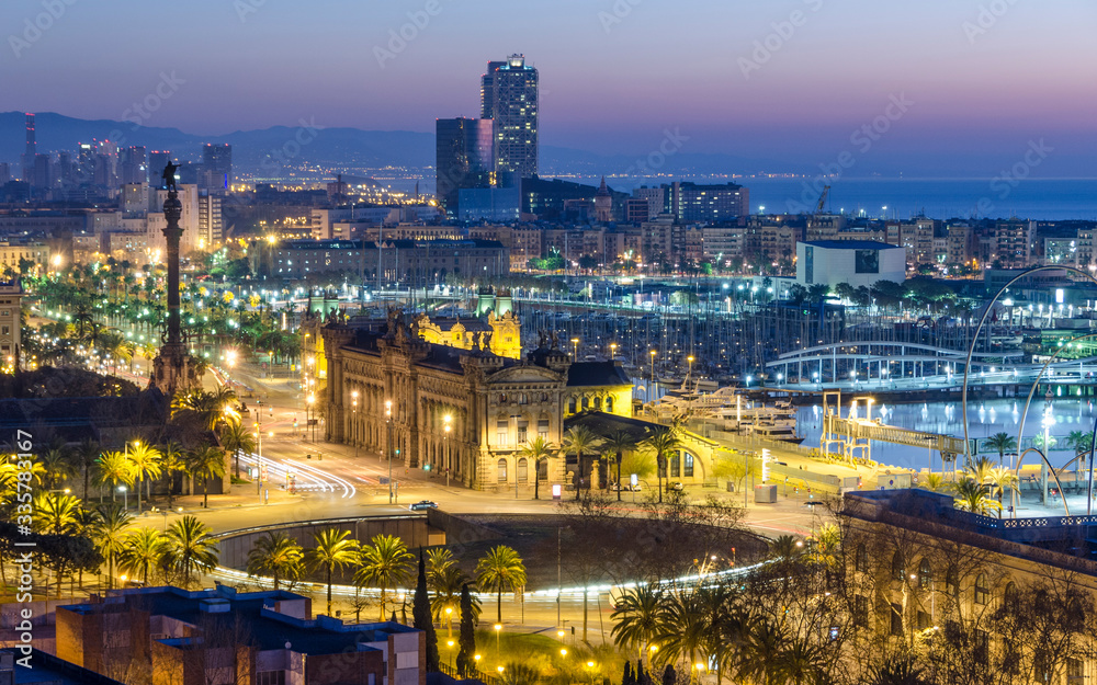 Panorama aéreo del paisaje urbano de la ciudad de Barcelona iluminada al anochecer.