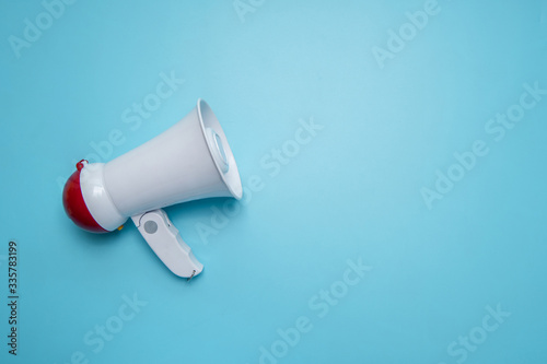 Megaphone announcement on blue background with copy space