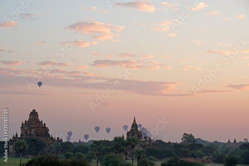 Landscape of ancient pagoda and balloon floating over the orange sky sunrise in the morning at Bagan , Mandalay , Myanmar - Scenery background