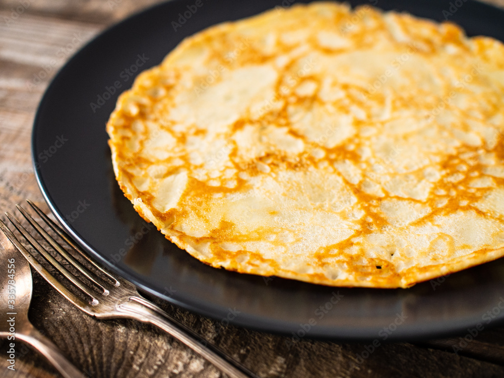 Sweet crepes with fruit jam on wooden table Sweet crepes with fruit jam on wooden table