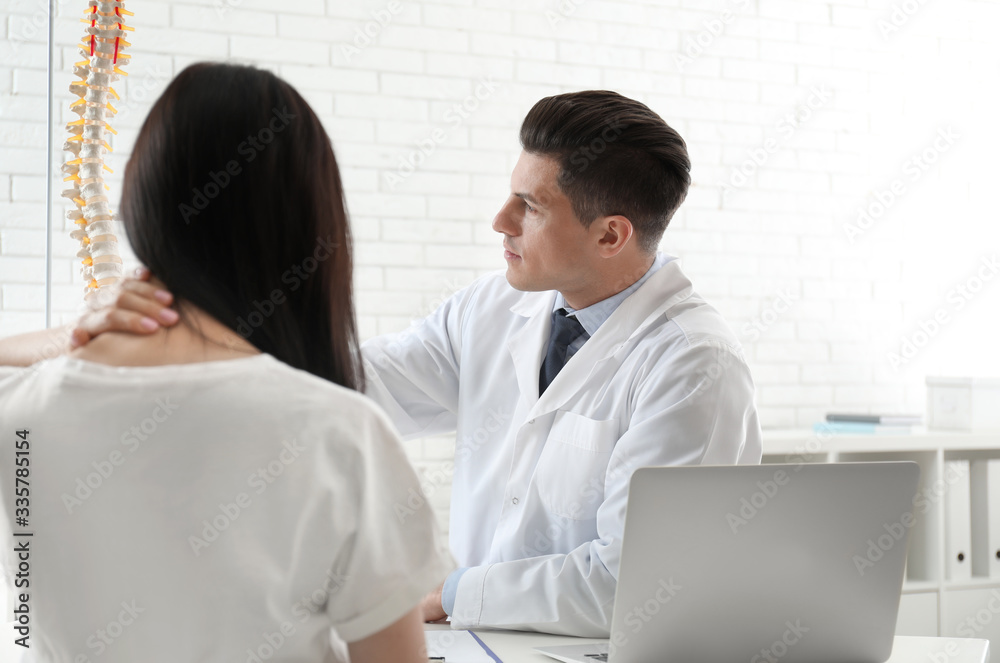 Young woman visiting orthopedist in medical office Young woman visiting orthopedist in medical office