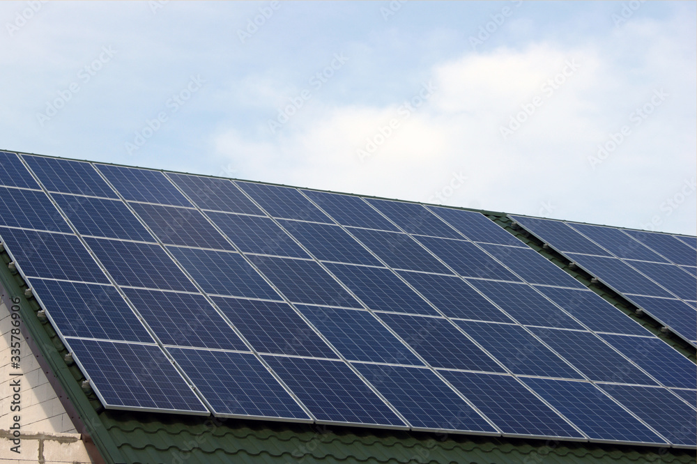 Fototapeta premium Solar panel on a green roof.