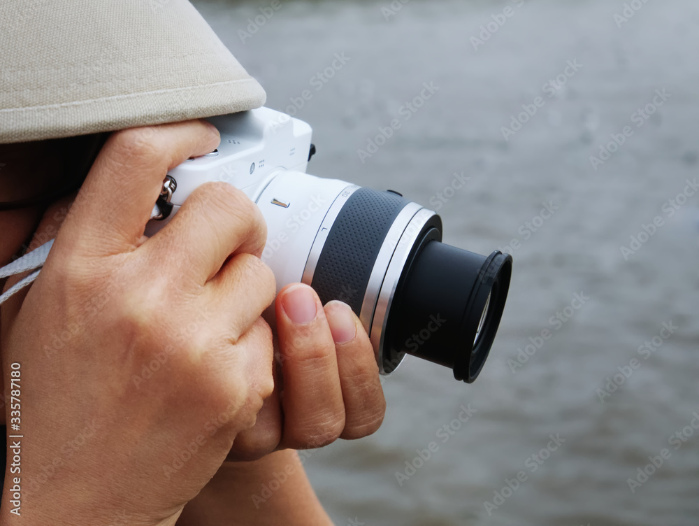 Close-up Unrecognizable Person Taking Photos with White Mirrorless Camera