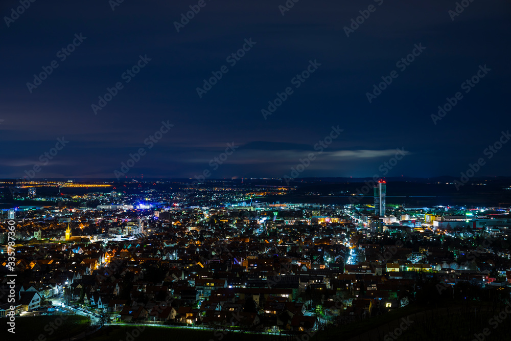 Germany, Magical night atmosphere over fellbach city skyline, aerial view above the houses by night