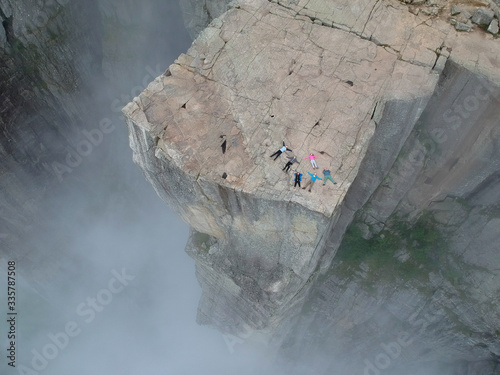 Drone view on tourists in Preikestolen and looking in te sky, Preikestolen - famous cliff in the mountains of Norway.