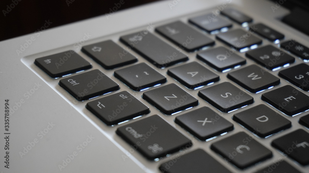 Photography close up shot of laptop or computer corner with keyboard keys Photography close up shot of laptop or computer corner with keyboard keys