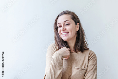 Happy girl smiling. Beauty portrait young happy positive laughing brunette woman on white background isolated. European woman. Positive human emotion facial expression body language.
