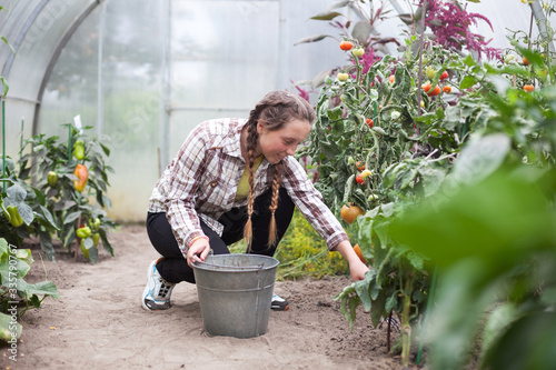  teenage girl in   greenhouse