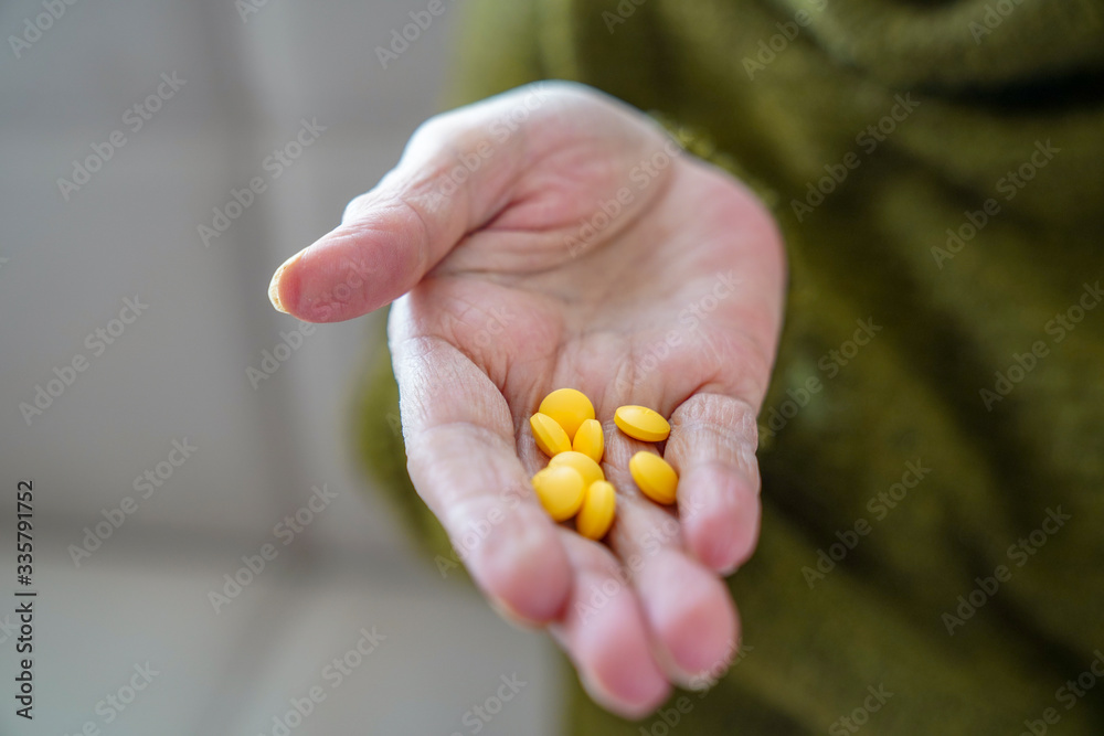 pills in a Senior's hands. Painful old age. Caring for the health of the elderly pills in a Senior's hands. Painful old age. Caring for the health of the elderly