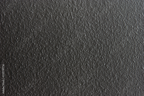 Uniform grey roughly textured wall 
