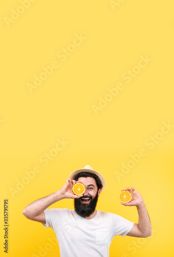 cheerful summer man in panama hat with oranges fruit, mock-up image with place for text