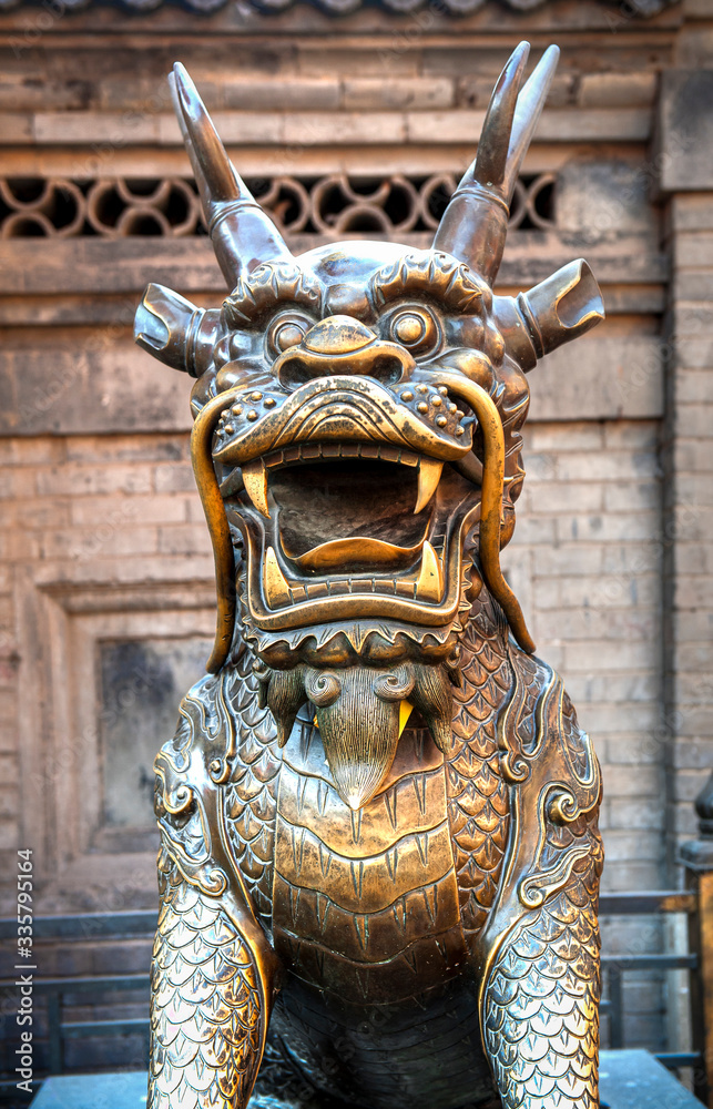 Bronze statue of a legendary Chinese dragon with horns and mustaches. Tianjin - China