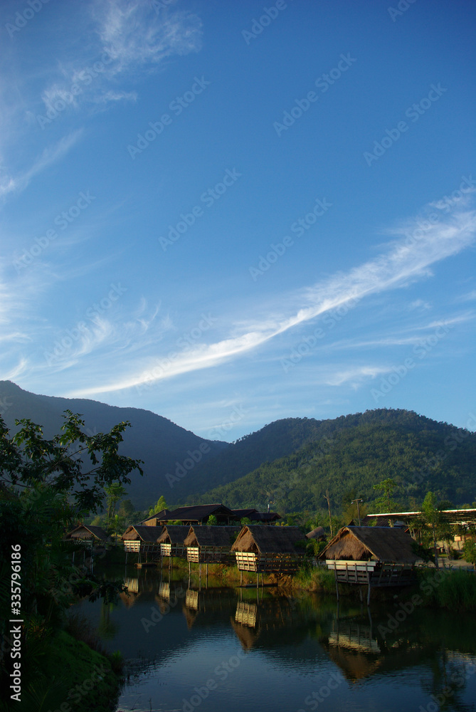 Naklejka premium In the morning light small huts beside the lake and the mountain view