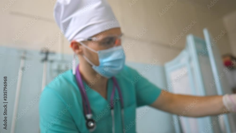 Scientist holding test tube with blood sample to coronavirus. Arm of laboratory worker with protective gloves testing blood samples on clinic. Concept of health and safety life from COVID-19 pandemic