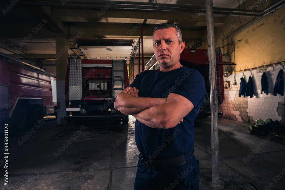 Portrait of fireman standing inside the fire department