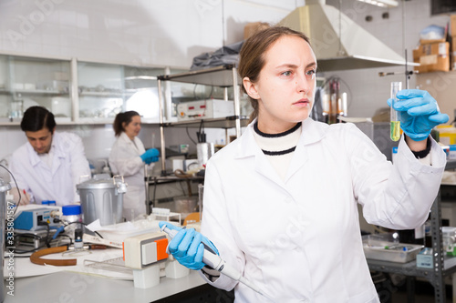 Fototapeta Naklejka Na Ścianę i Meble -  Female student examining chemical substances