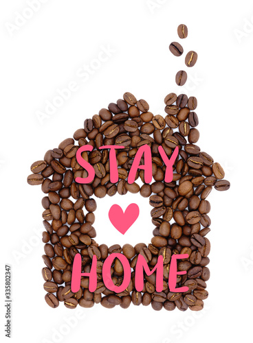 Coffee beans in the shape of a house with inscription 'Stay home' isolated on white background. Home decor poster. Coronavirus Covid-19 awareness. Quarantine motivational phrase.